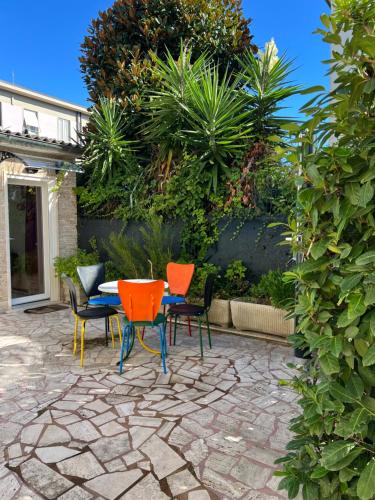 a patio with a table and chairs on a stone patio at Orchidea in Viareggio