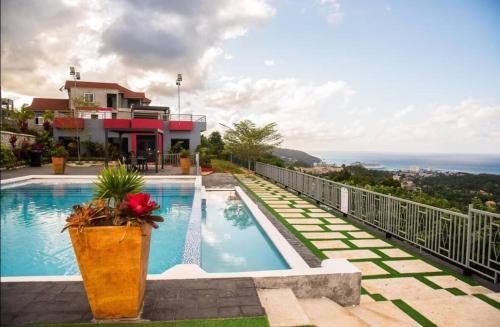 a swimming pool on the side of a house at Summerbreeze at Pyramid Point in Breadnut Hill