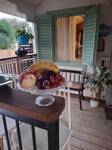 a bowl of fruit on a table on a porch at הבקתה של רינת in Me‘ona