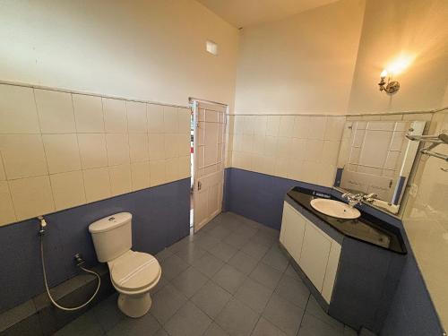 a bathroom with a toilet and a sink at Pineridge Hotel at Mall Road in Darjeeling