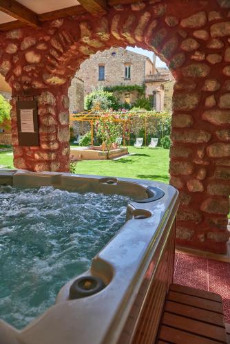 a jacuzzi tub in a stone building at Les Arcades Le Lion D'or in Buis-les-Baronnies