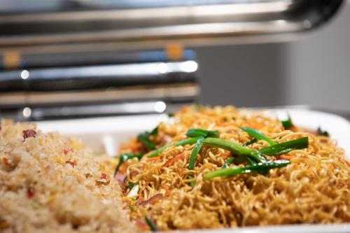 a plate of food with rice and green onions at Atour Hotel Shiguang Road Panyu Guangzhou in Guangzhou