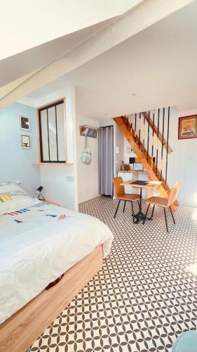 a bedroom with a bed and a table and chairs at VILLA JULIETTE in Dunkerque