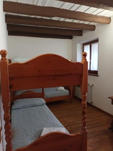 a bedroom with a wooden bed in a room at Isola della Cona - Riserva naturale Foce dell'Isonzo in Staranzano
