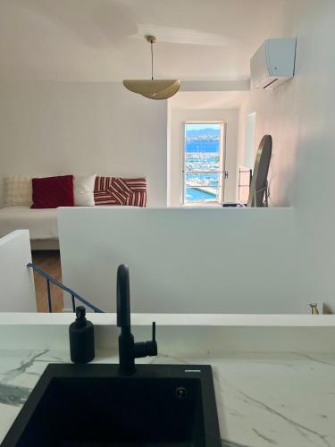 a kitchen and living room with a sink in a room at Maison BOBLEU in Bandol