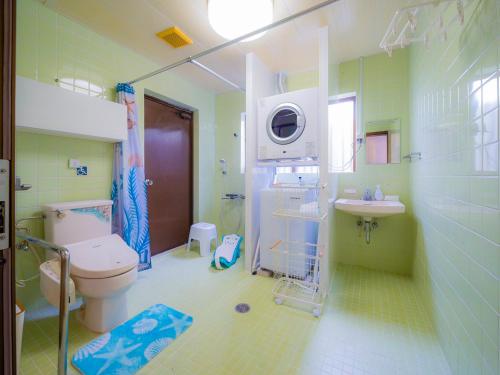 a bathroom with a toilet and a sink and a shower at 琉球乃風-プチョヘンザ- in Uruma