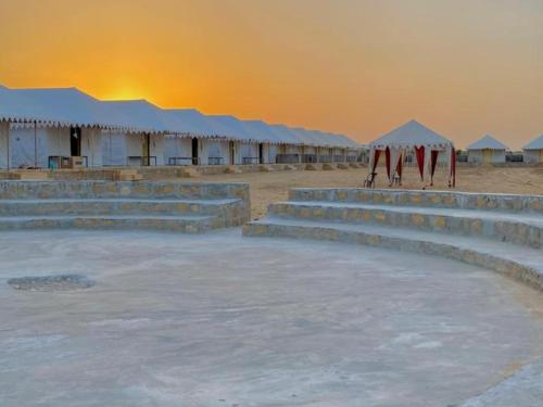 a set of concrete steps in a desert with tents at Sand Routes Resort & Desert Camp in Sām