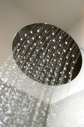 a shower head with a bunch of water at WM Apartments in Edinburgh