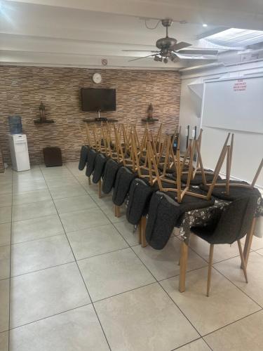 a room with a row of chairs and a white board at Surrey B&B in Surrey Estate