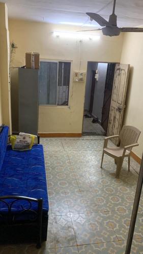 a living room with a couch and a table and a chair at Tripathi Villa in Murbād