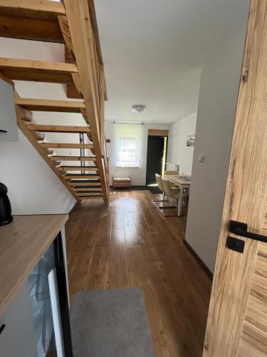 a living room with stairs leading to a dining room at Apartamenty u Jakubika in Krynica Zdrój