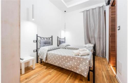 a bedroom with two beds and a mirror at Colombo House in Quartu SantʼElena