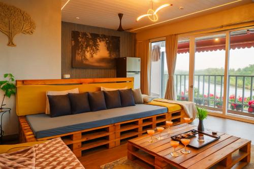 a living room with a couch and a table at Vista Villa- A Riverside Villa in Alibaug in Mamnoli