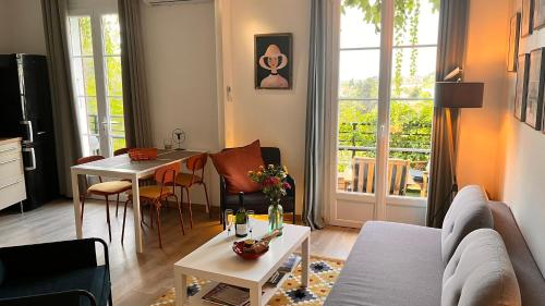 a living room with a couch and a table at Les Capucines, comme chez soi, loin de chez soi in Aubenas