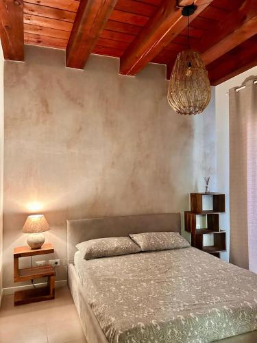 a bedroom with a bed and a chandelier at Casa Baldi | Centro storico di Rimini in Rimini