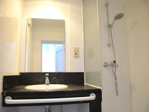 a bathroom with a sink and a mirror at Family Retreat, Forested Anhée in Denée