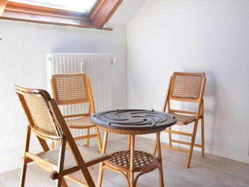 a table and chairs in a room with a window at Family Retreat, Forested Anhée in Denée