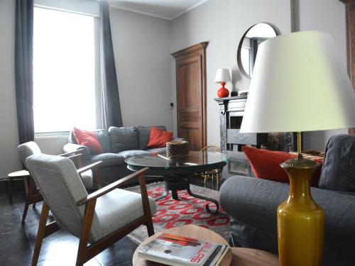 a living room with a couch and a table at Family Retreat, Forested Anhée in Denée