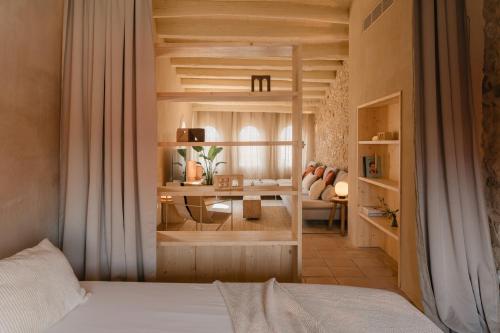 a bedroom with a bed and a desk in a room at Casa boutique a Vilamacolum in Vilamacolum
