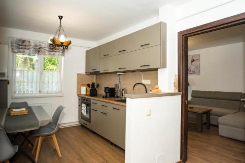 Una cocina y una sala de estar con una mesa. en Apartment in Odorheiu Secuiesc, en Văleni