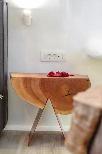 a wooden table with a clock on top of it at Naxos Island Escape Suites in Plaka