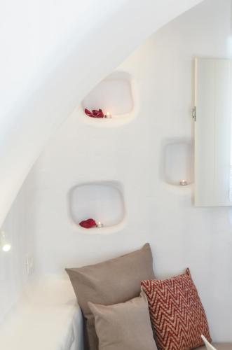 a white wall with two lights above a couch at Naxos Island Escape Suites in Plaka