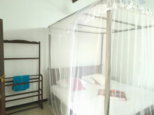 a bedroom with a bed and a glass shower at Ging View Villa in Galle