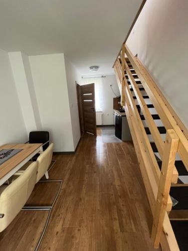 a room with a staircase and a living room at Apartamenty u Jakubika in Krynica Zdrój