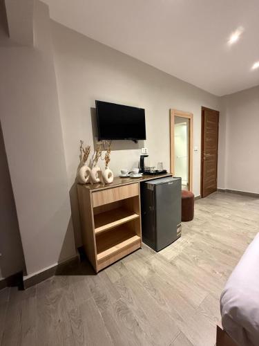 a room with a flat screen tv on a wall at Zlato Pyramids View INN in Cairo