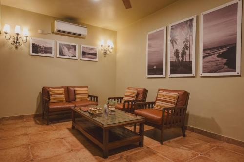 a living room with chairs and a coffee table at Brij Paraiso Saligao, Goa - An Indo-Portuguese Villa in Calangute