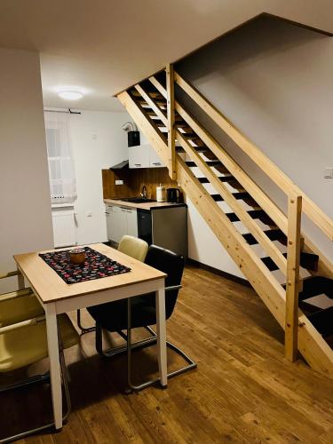 a small kitchen with a table and a staircase at Apartamenty u Jakubika in Krynica Zdrój