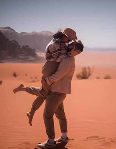 a man hugging a woman in the desert at Catalina Luxury rum camp in Wadi Rum
