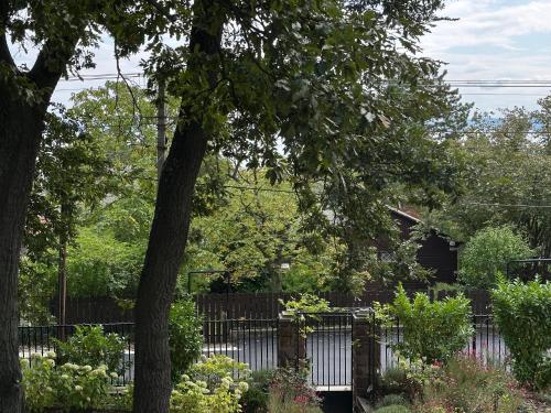 a yard with a fence and a garden with flowers at Villa Chez les Amis - Adults only in Balatonszepezd