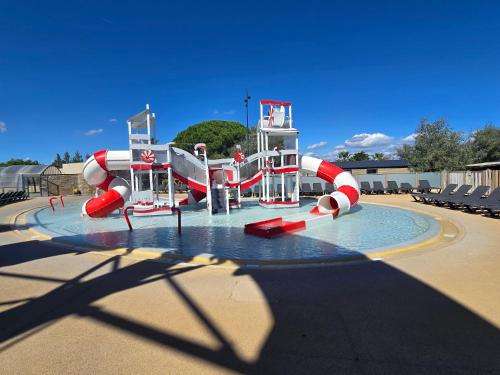 a water park with a water slide at Mobil Home Cosy Plage à 50 m Camping 5 in Torreilles