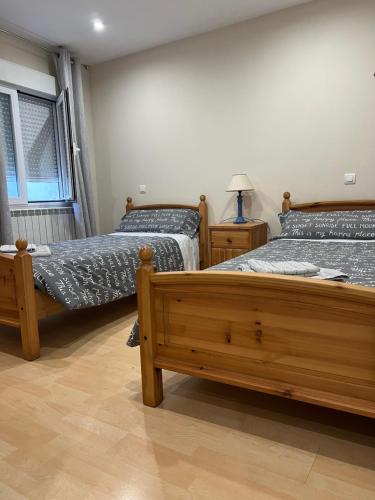 a bedroom with two beds and a lamp in it at Origen HARO ventilla in Haro