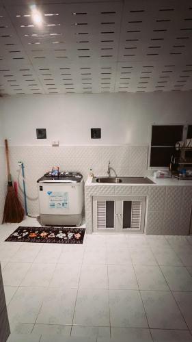 a kitchen with a sink and a tub in a room at Kood Life in Ko Kood