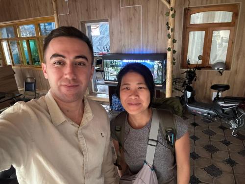 a man and a woman posing for a picture at Soy Buyi Garden in Fergana