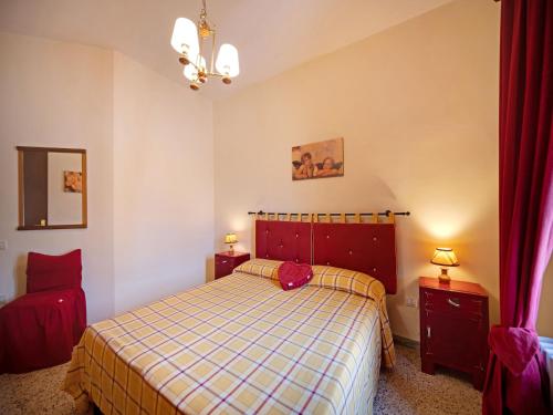 a bedroom with a bed with a checkered blanket at Mansion in Prodo near Lake Bolsena in Prodo