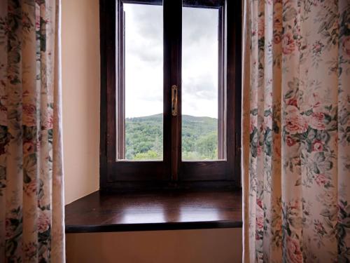 a window with a view of a mountain at Mansion in Prodo near Lake Bolsena in Prodo