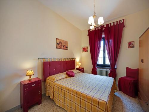 a bedroom with a bed and a window with red curtains at Mansion in Prodo near Lake Bolsena in Prodo