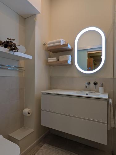 a bathroom with a sink and a mirror at Sand - Rooftop Views, Wine Cellar & Espresso in Senglea