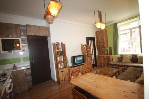 a kitchen and living room with a table and a couch at Full Apartment in Yerevan
