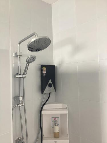 a bathroom with a shower and a toilet in a room at Naris Riverside in Ban Wat Tha Maprang