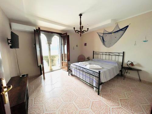 a bedroom with a bed and an umbrella on the wall at Villa dei Saraceni in Furore