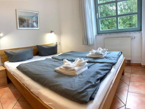 Katil atau katil-katil dalam bilik di Ferienhaus Südstrand