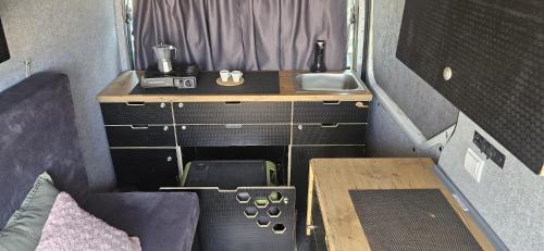 a small room with a sink and a desk at Van Master in Puerto del Rosario