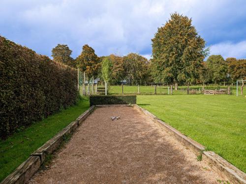 a bird is sitting in the middle of a field at Spa Cottage in Fagnes in Waimes