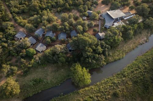 an aerial view of a house next to a river at Karongwe - Becks Safari Lodge in Hoedspruit