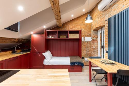 a room with a bed in a kitchen with a table at La Dolce Suite Porta Romana Metro in Milan