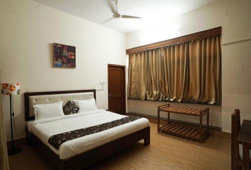 a bedroom with a large bed and a window at The Harmony Circle - Jaipur in Jaipur